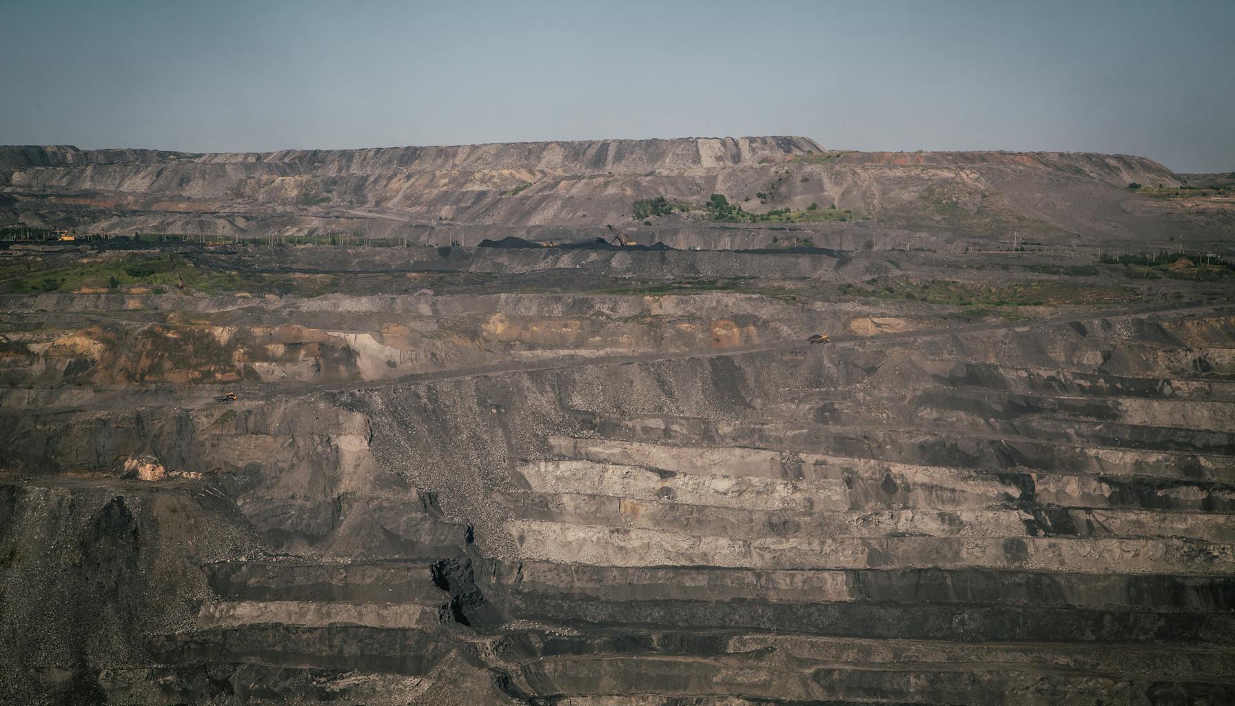 Open-pit mining operation showcasing mineral extraction and geological formations